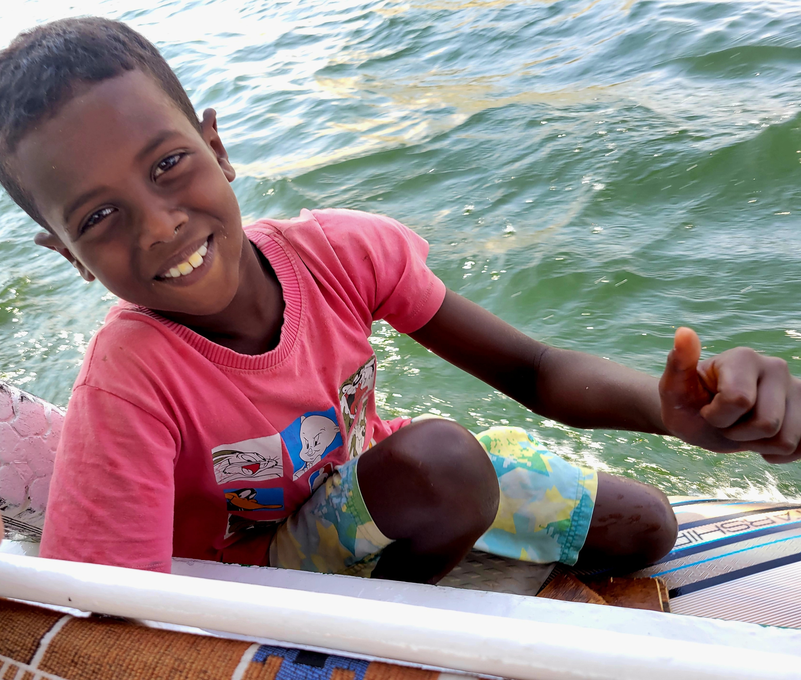 A smiling boy on a boat on the Nile near Aswan