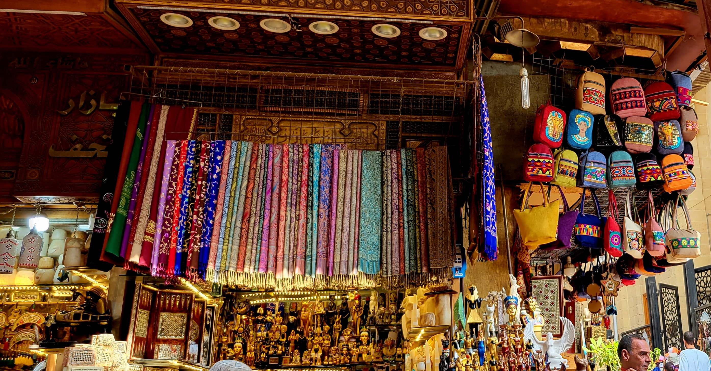 Colorful wares and textiles displayed at a Cairo market stall