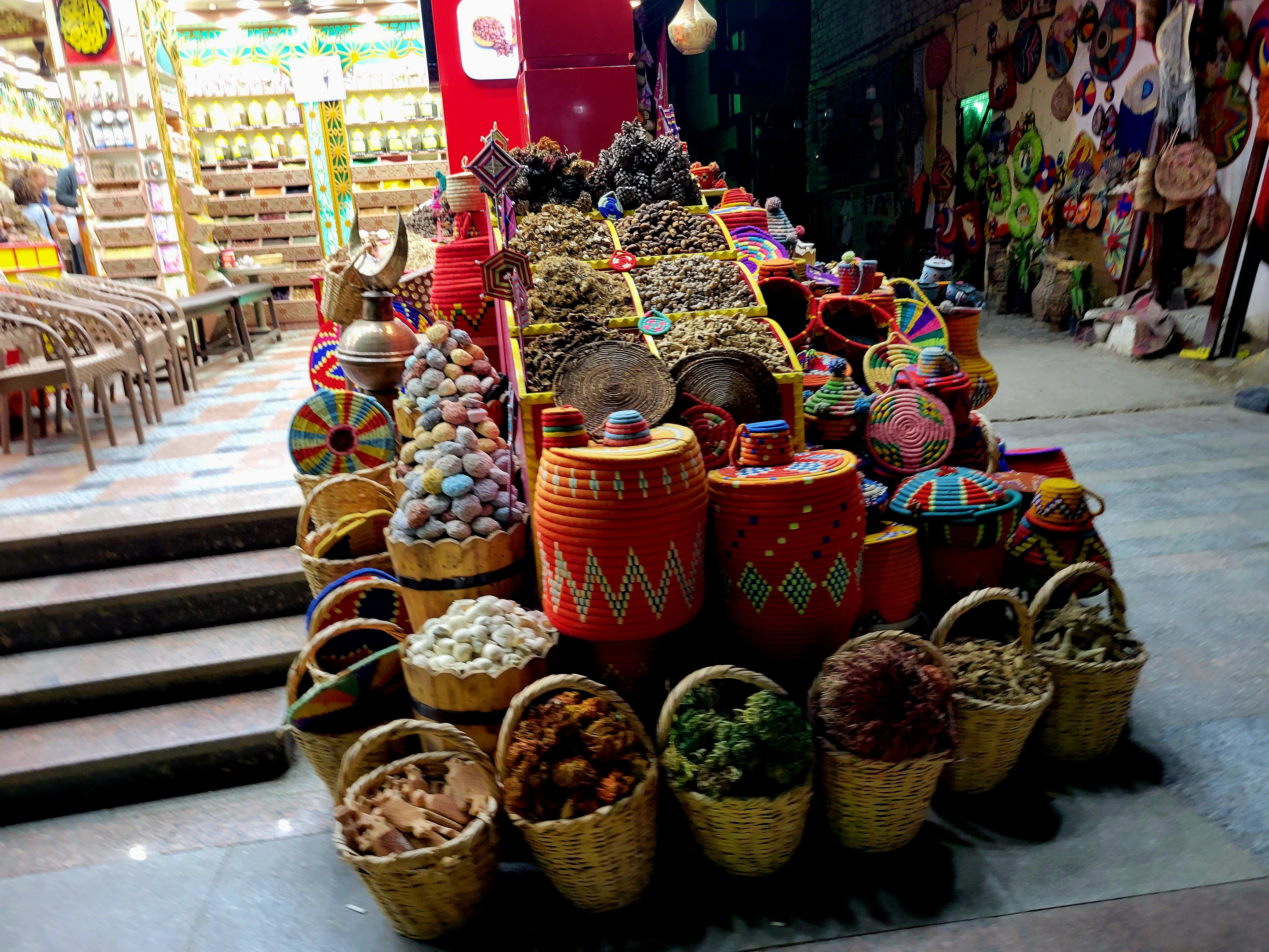 Bins overflowing with colorful spices and dried goods at an Egyptian market