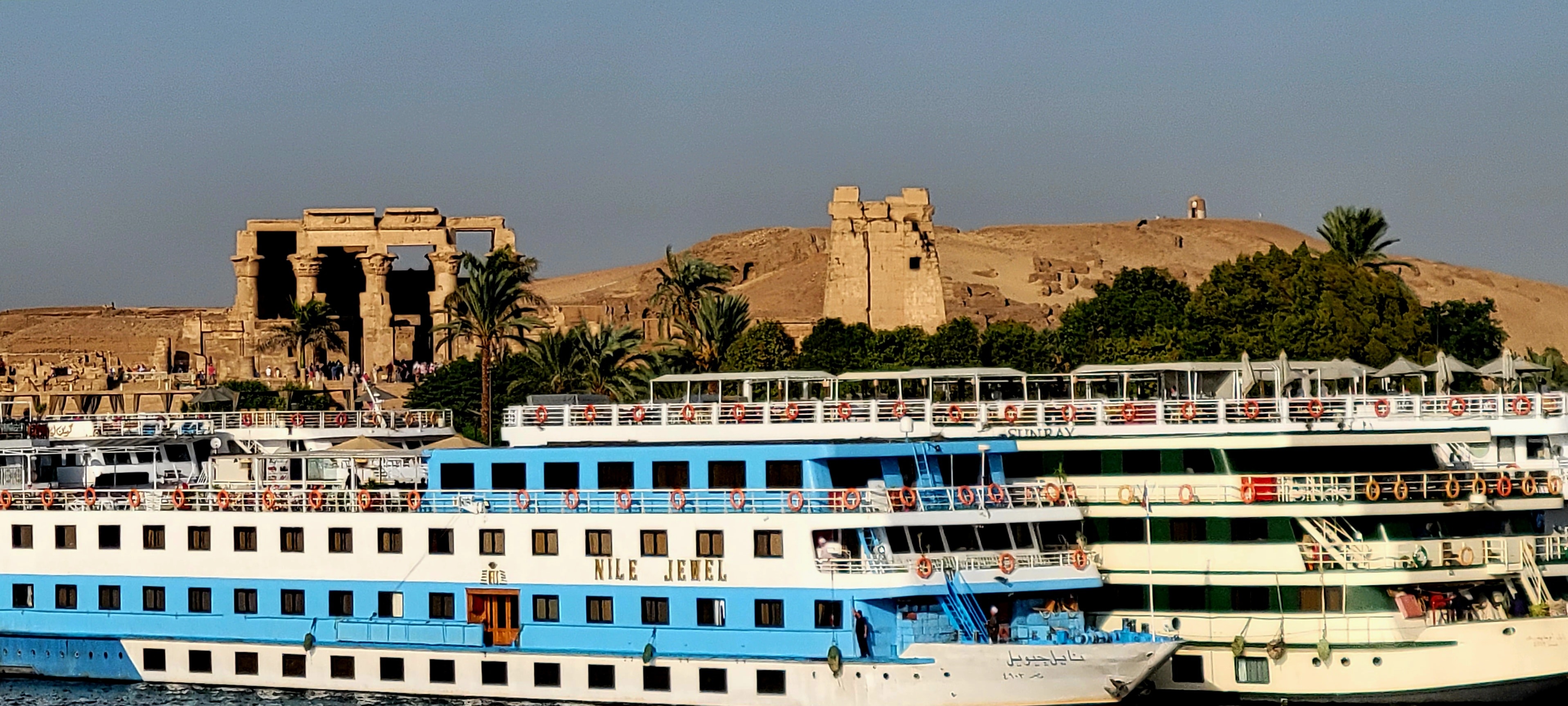 The Nile Jewel cruise ship docked in front of the ancient Temple of Kom Ombo