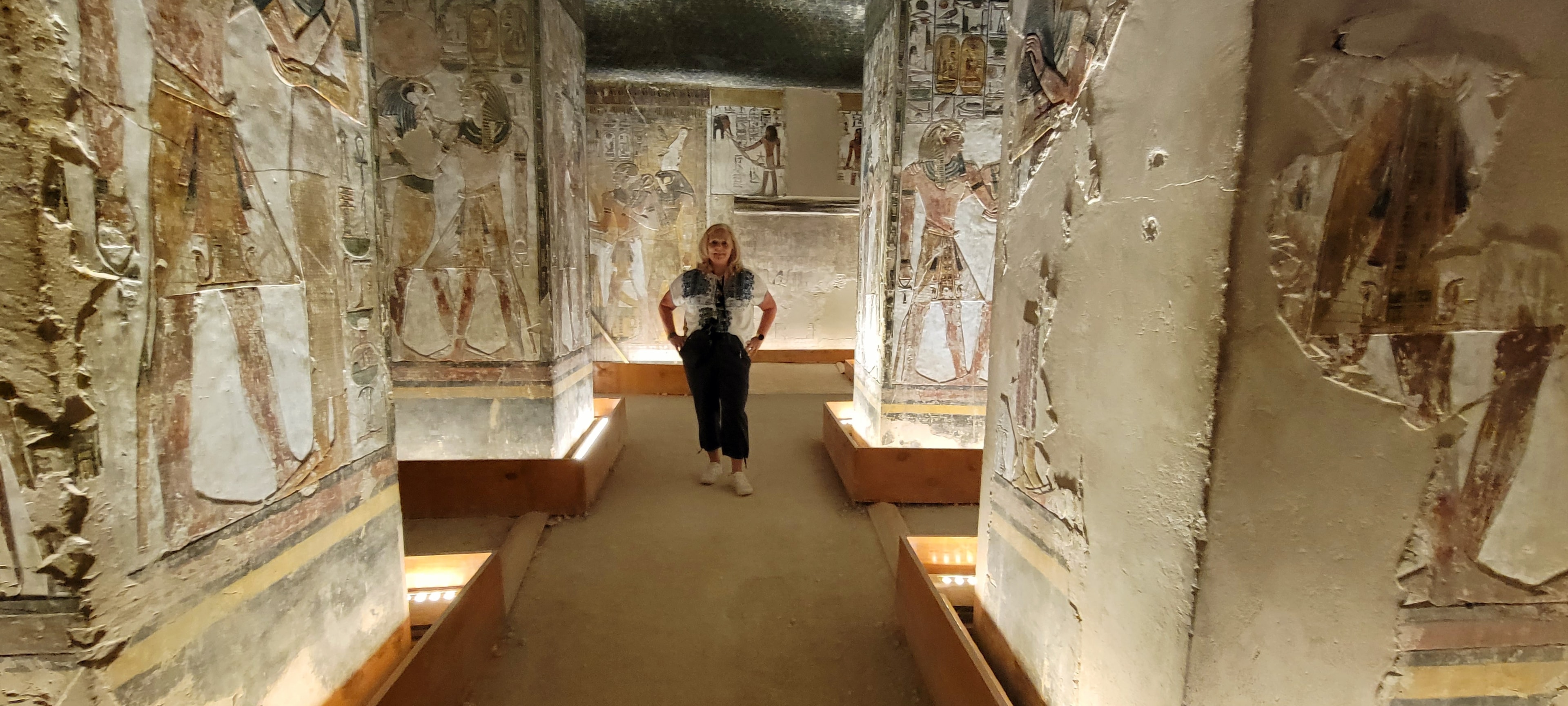 Linda standing in a brilliantly painted tomb corridor in the Valley of the Kings