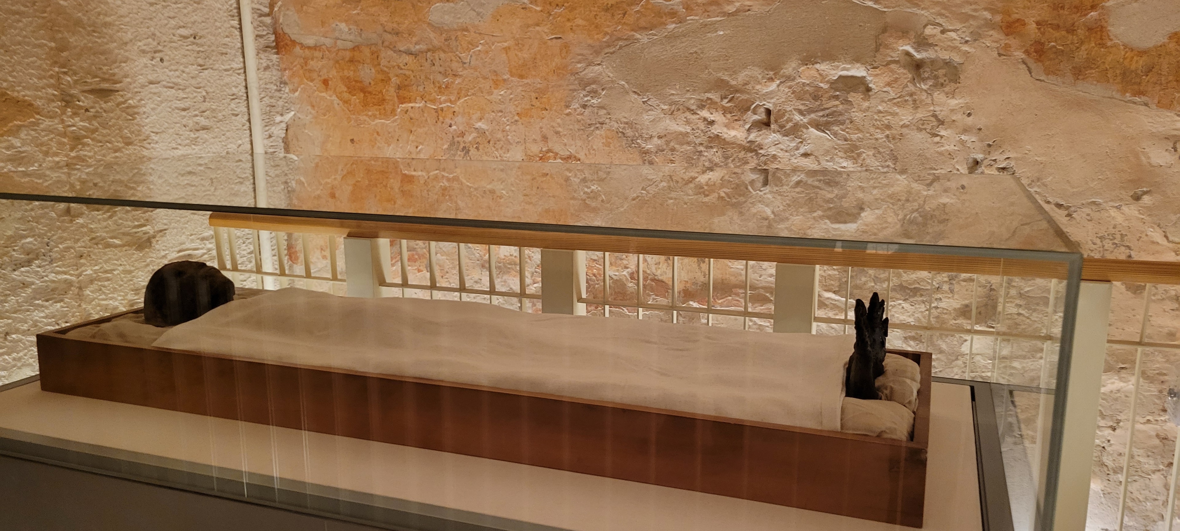 King Tutankhamun lying at rest in his glass case inside the Valley of the Kings