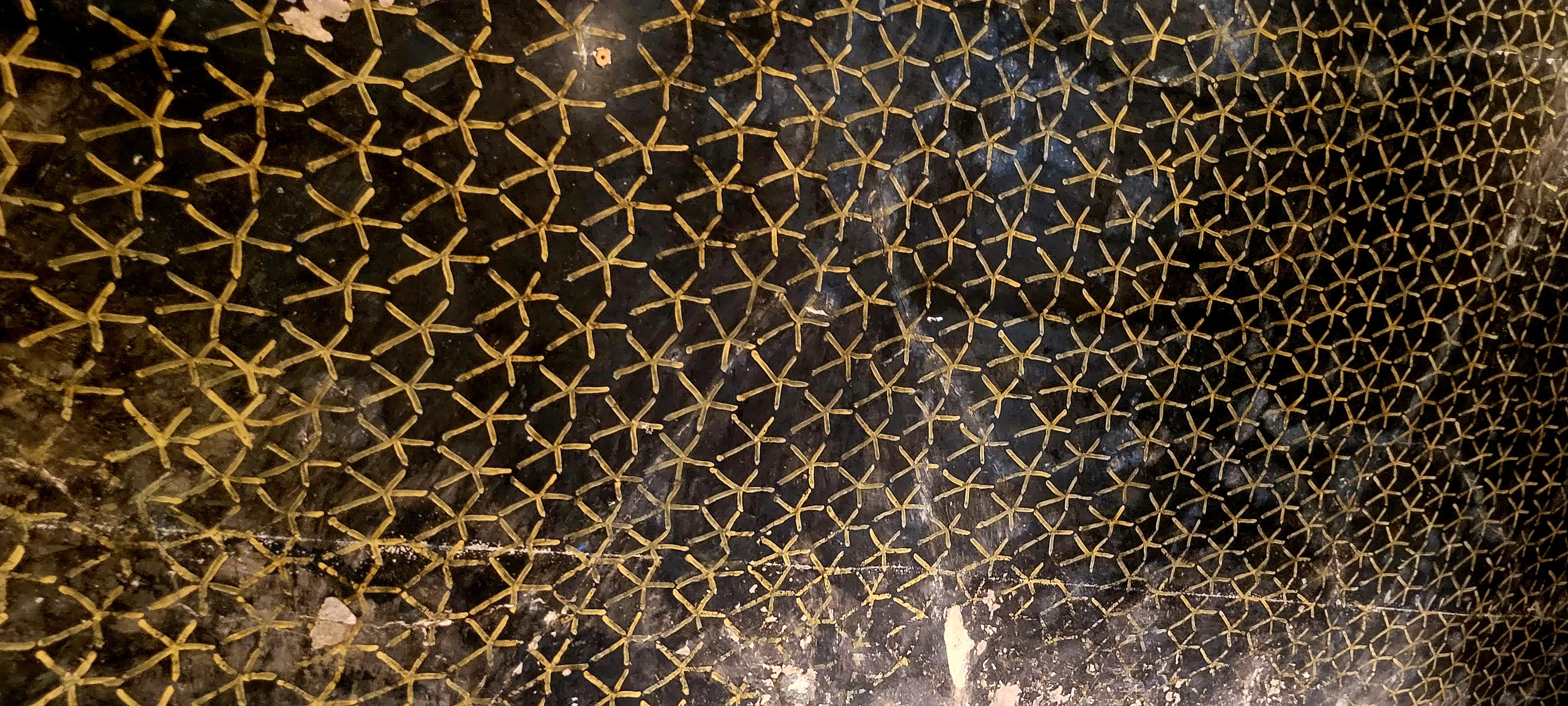 The ceiling of Queen Nefertari's tomb — black background with a vivid gold star pattern
