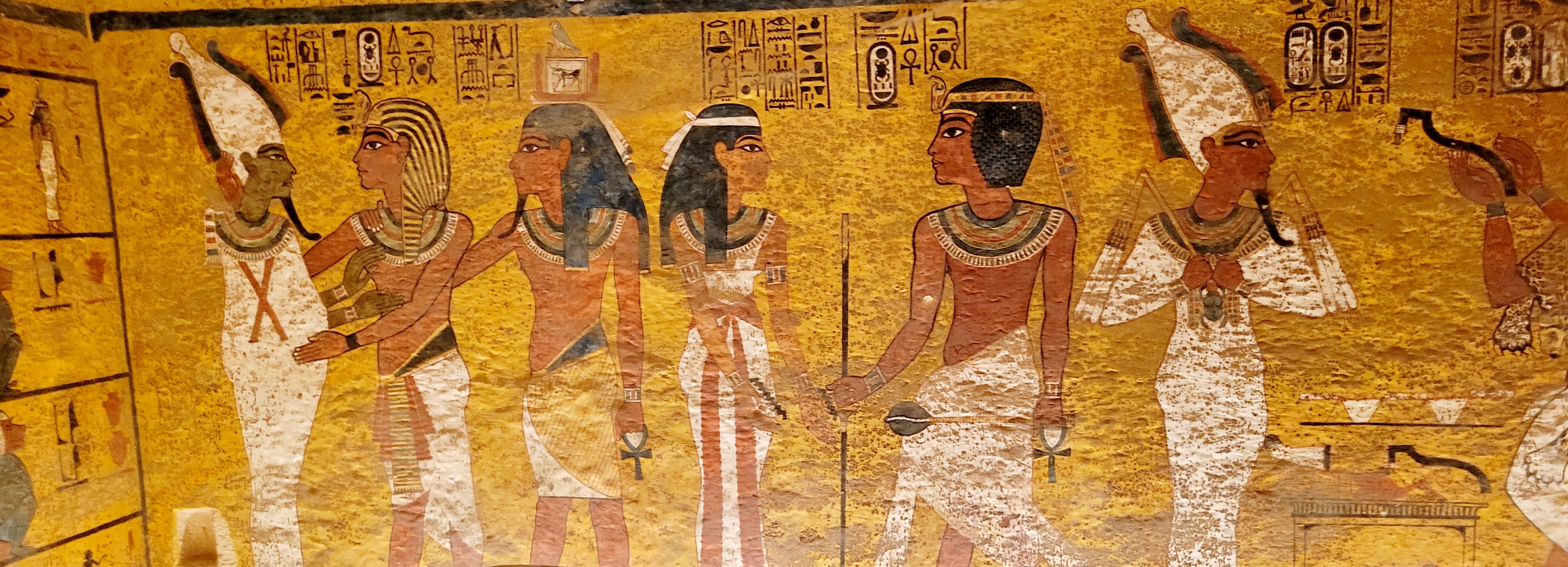 Vivid ancient Egyptian tomb paintings showing pharaohs and gods with hieroglyphics